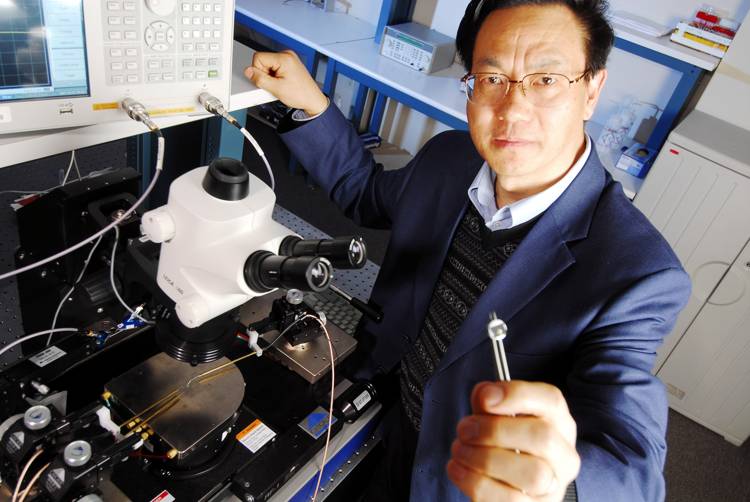 Zhong Lin Wang holds a prototype direct current (DC) power piezoelectric nanogenerator (NG)